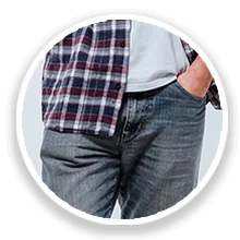 Man in jeans with hand in pocket, worried about dribbling after urination